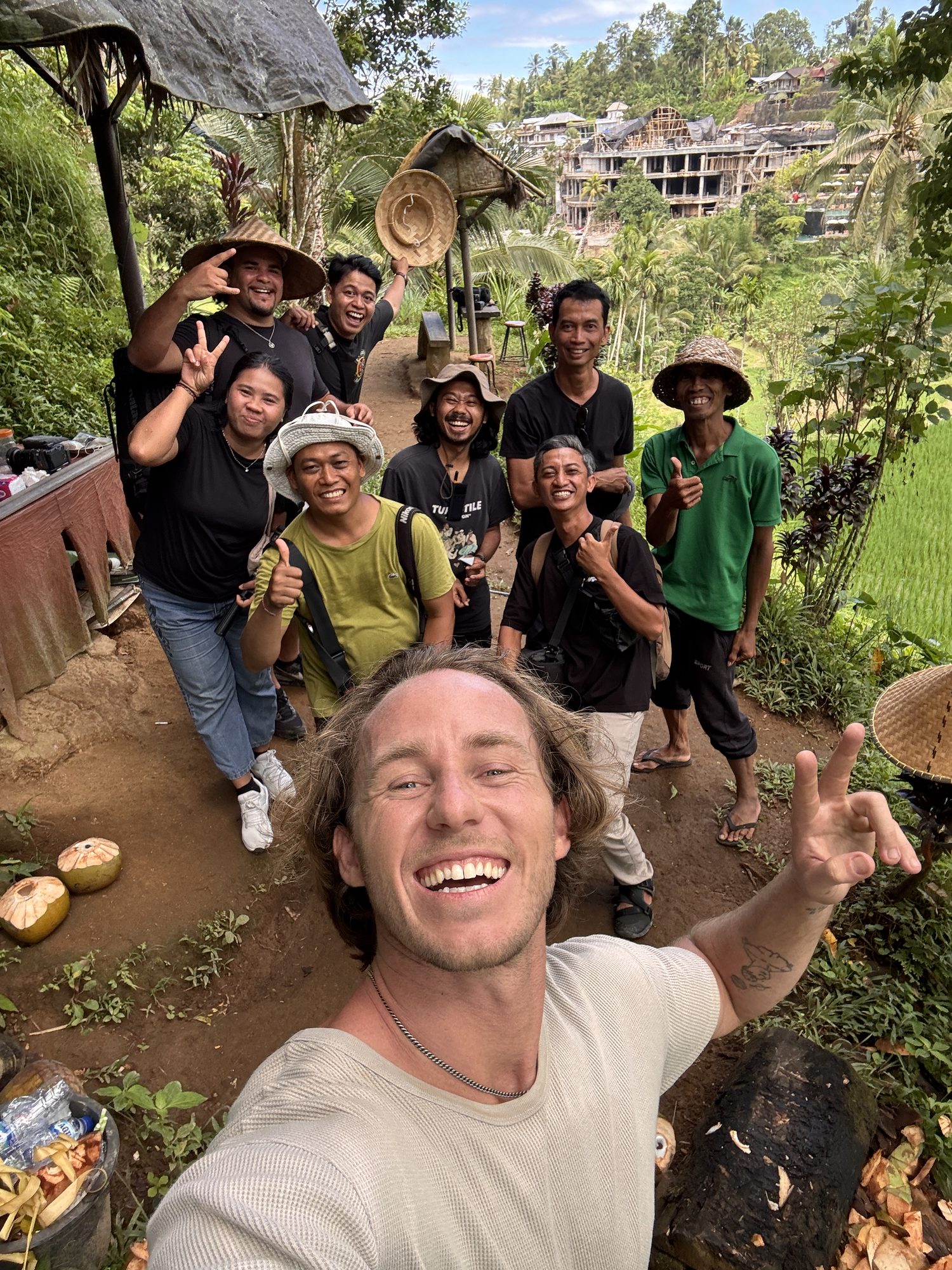 Jaro taking a group selfie with the local Balinese production crew in a rice field