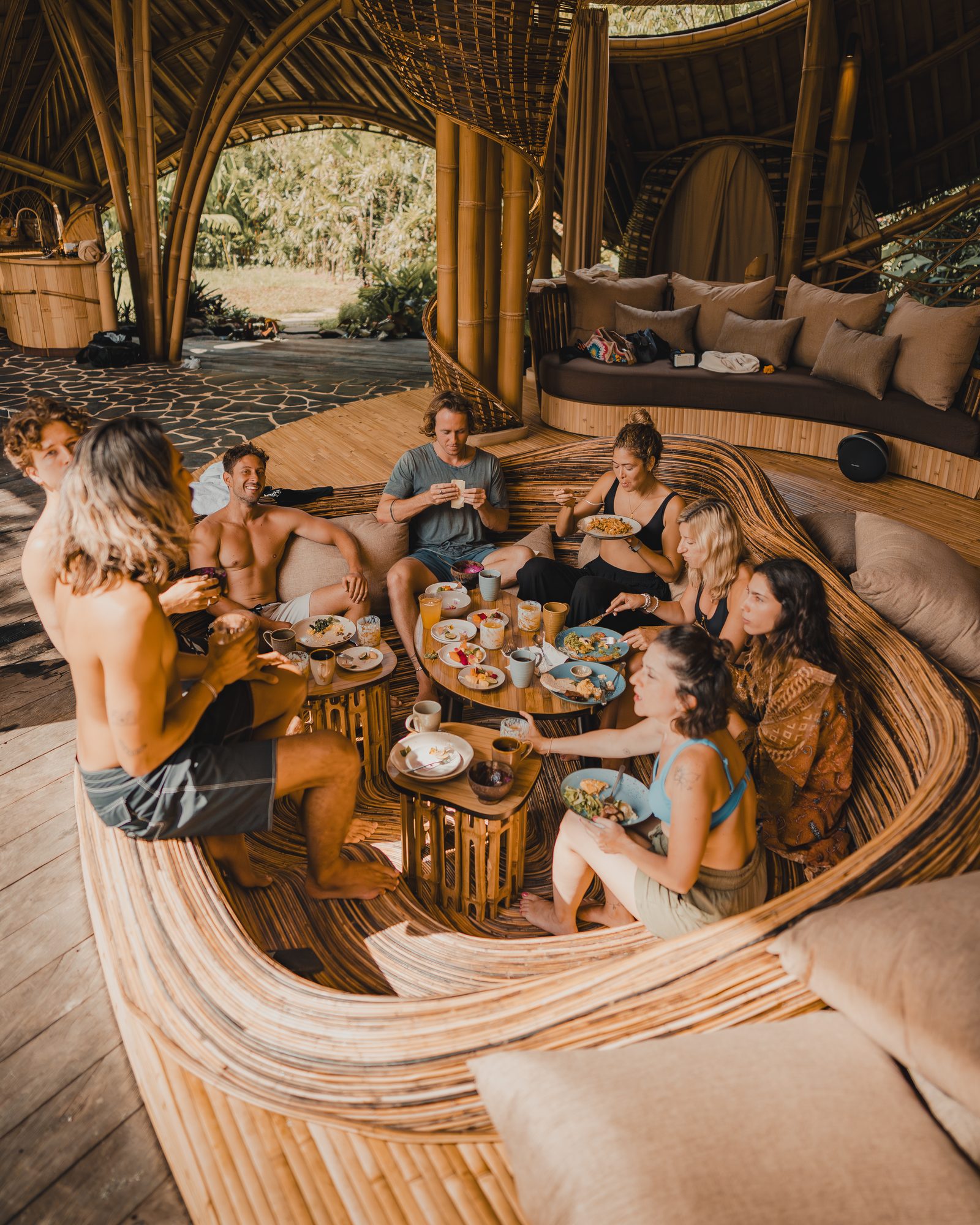 Jaro and a group of creators sharing breakfast in a bamboo pavilion, Bali