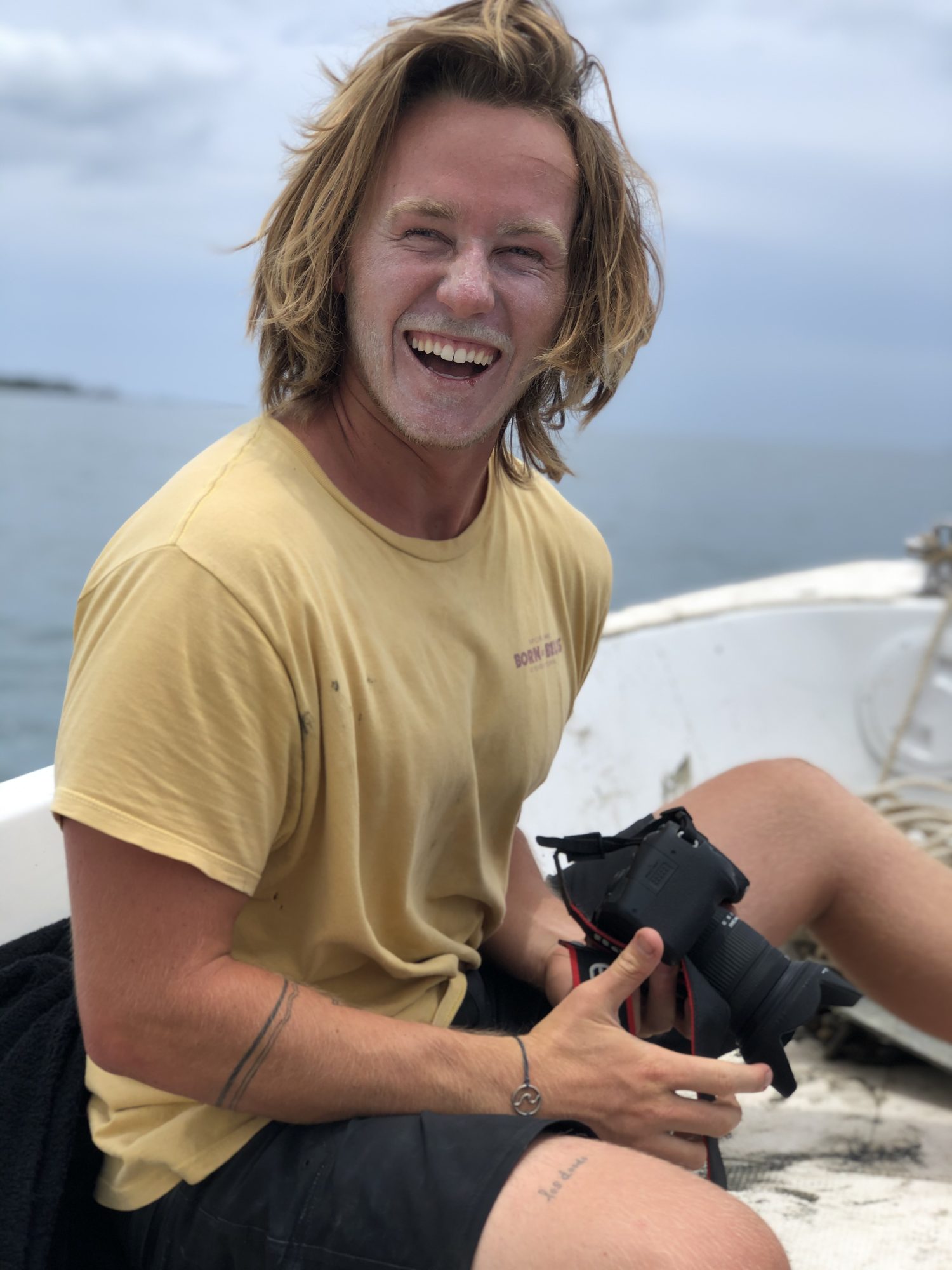 Jaro today, laughing while holding his camera on a boat